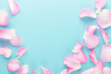 Wall Mural - Rose flowers petals on pastel background. Valentines day background. Flat lay, top view, copy space.