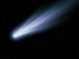 Glowing comet in the starry sky. Observation of celestial objects. Real photography of a comet's tail against a background of stars.