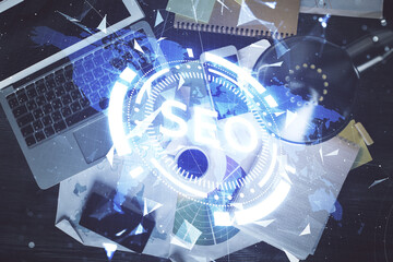 Poster - Double exposure of SEO drawing over study table background with computer. Concept of search. Top view.
