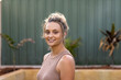 © Austockphoto - head and shoulders of tanned young woman looking at camera