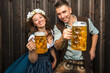 © karepa - Oktoberfest, woman and man in Bavarian costume with beer mugs