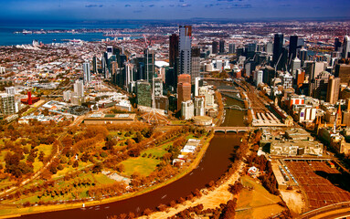 Canvas Print - MELBOURNE, AUSTRALIA - SEPTEMBER 8, 2018: Aerial view of city central business district and Yarra River from helicopter.