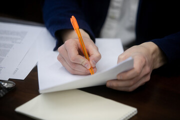 Canvas Print - Businessman signing a document after reading the agreement in office