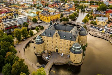 Wall Mural - Drone shot of the beautiful Orebro Castle surrounded with Svartan river and the cityscape of Sweden