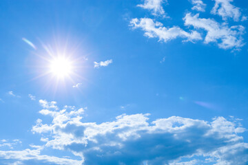 blue sky with clouds and bright sun. weather, atmosphere, season.