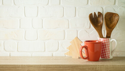 Wall Mural - Red coffee or tea cup with kitchen utensils  and Christmas decoration on wooden table Winter holiday mock up for design and product display