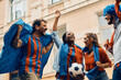 © Drazen - Below view of cheerful soccer fans celebrating victory of their team.