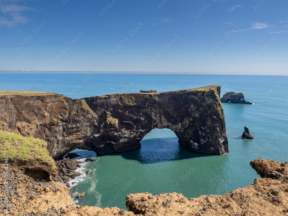 The iconic black sand beaches of Reynisfjara and the sea stacks ...