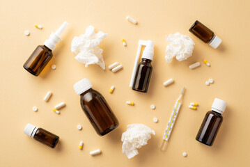 Wall Mural - Illness concept. Top view photo of medicines spray and syrup transparent brown bottles pills capsules thermometer and crumpled paper napkins on isolated beige background