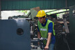 Asian male engineer working in the industry factory. Asian male technician worker maintaining machines in the factory