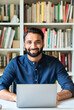 © insta_photos - Happy smiling indian ethnic professional business man teacher sitting at work desk with laptop computer remote working at home office or learning online, vertical portrait. Business education concept