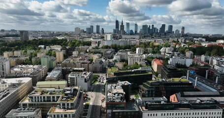 Poster - Flying above buildings and streets in Warsaw, Polish capital. City skyline with skyscrapers on the horizon