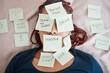 © C Davids/peopleimages.com - Tired, sticky note and sleeping woman in overworked, schedule or overwhelmed with work and tasks on bed. Female worker covered in paper, pressure and bedroom chaos or information overload at home