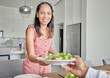 © Lumeez I/peopleimages.com - Wife, healthy food and salad while serving lunch or supper for husband with a smile at home. Caring and happy housewife woman with a dinner plate and enjoying a vegan meal at the table together
