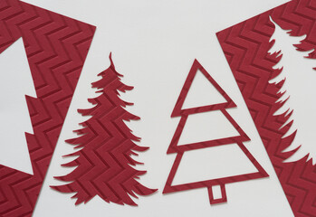 Poster - mostly red stylized holiday tree cutouts on beige ivory paper