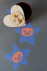 Wall Mural - wooden skull mask (with slight burnt effect) and decorative halloween patterns (faint blue stars with orange jack o lanterns)