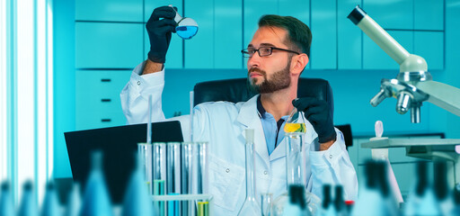 Poster - chemist watching chemical process in flask. scientist in gloves pouring blue acid into test tube wit