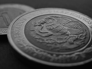 Wall Mural - Coin of 5 five Mexican pesos closeup. Peso of Mexico. Reverse of coin with coat of arms of country. Eagle and snake. Black and white background. News about economy or banking. Credit and money. Macro