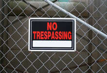 No Trespassing Warning Sign On Iron Chain Link Fence