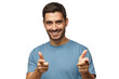 © Damir Khabirov - Portrait of young happy man smiling while looking at camera pointing to viewer with fingers of both hands as if approving