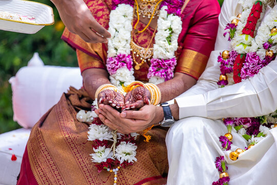 South Indian Tamil couple's wedding ceremony ritual items and hands close up