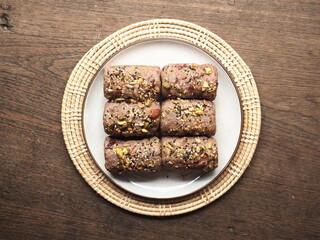 Wall Mural - Cereal and nut crusted bread rolls on white plate