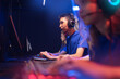 © Parilov - Professional gamer of team computer players, asian young man play online video games, neon color, soft focus