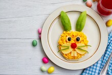 Scrambled Eggs Bunny Toast-toast With Scrambled Eggs,cheeses,tomato,avocado,black Olives And Cucumbers On Plate With Wooden Background.Creative Art Food Idea For Kid Breakfast.Top View.Copy Space