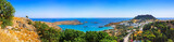 Fototapeta  - Panoramic view of colorful harbor in Lindos village and Acropolis, Rhodes. Aerial view of beautiful landscape, ancient ruins, sea with sailboats and coastline of island of Rhodes in Aegean Sea
