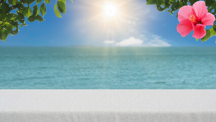 Display background of blurred ocean with blue sky,sunlight and hibiscus-Top of the table is empty ready for your product