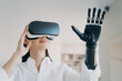Advertising of bionic prosthetic arm. Woman in VR glasses touches virtual object by prosthesis