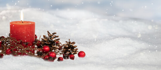 Wall Mural - natural christmas decoration outdoors in snow, red burning candle with pine cones and berries decorated, white greeting card banner background for winter holiday season