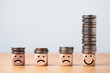 © Dilok - Coin stacking on smiley face and sad face for good financial planing can make happiness in life, Money saving and investment concept.