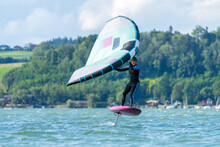 Woman Wing Foiling On Lake Wallersee, Salzburg, Austria