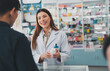© Me studio - female pharmacist at drugstore.Health care pharmacists work at the hospital.Pharmacist looking at male customer.Doctor specialists organize prescription medications.
