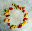 © RooM The Agency - Overhead view of assorted red, green and yellow chilli peppers arranged in a circle