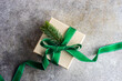 © RooM The Agency - Overhead view of a rustic gift box tied with a ribbon and decorated with a fir branch