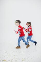 Preschool boy, girl in Christmas sweaters