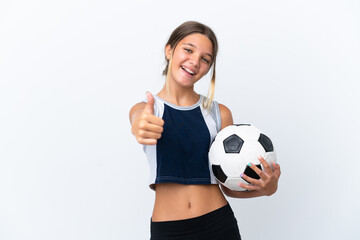 Wall Mural - Little caucasian girl playing football isolated on white background with thumbs up because something good has happened