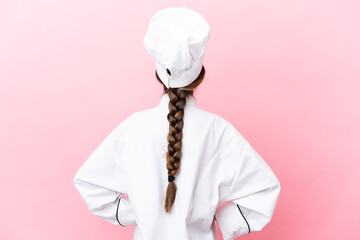 Sticker - Little caucasian chef girl isolated on pink background in back position