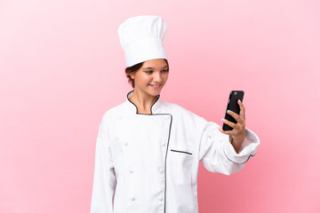 Sticker - Little caucasian chef girl isolated on pink background making a selfie