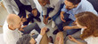 Cheerful and friendly team of office colleagues sitting in circle and chatting during work break. Top view of smiling multiracial people talking and sharing interesting stories. Web banner.
