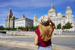 Holidays in Liverpool, UK. Beautiful young woman visiting Pier Head with 