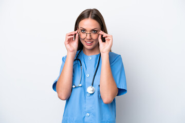 Young nurse caucasian woman isolated on white background with glasses and surprised