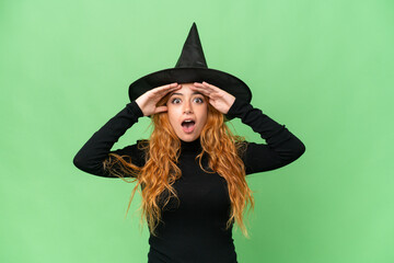 Wall Mural - Young caucasian woman costume as witch isolated on green screen chroma key background with surprise expression