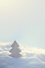 Wall Mural - christmas tree with sunlights stands on white snow