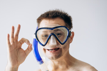 Handsome man in diving mask standing and looking at camera.