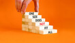 © Dzmitry - One size does not fit all symbol. Concept words One size does not fit all on wooden blocks. Businessman hand. Beautiful orange background. One size does not fit all business concept. Copy space.