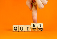 Quiet Quitting Symbol. Concept Words Quiet Quitting On Wooden Cubes. Businessman Hand. Beautiful Orange Table Orange Background. Business Quiet Quitting Concept. Copy Space.