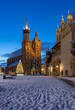 St Mary's church and Cloth Hall on snow covered Main Square in winter Krakow, illuminated in the night